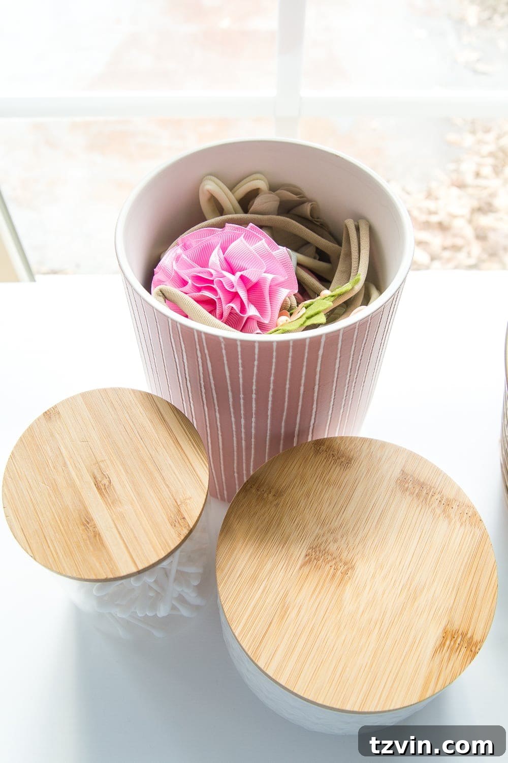 Nursery Organization Secrets Revealed 5 Nursery Organization | Use lidded canisters from the kitchenware aisle to store headbands and bows.
