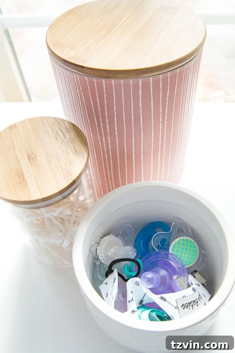 Nursery Organization Secrets Revealed 6 Nursery Organization | Use lidded canisters from the kitchenware aisle to store pacifiers.