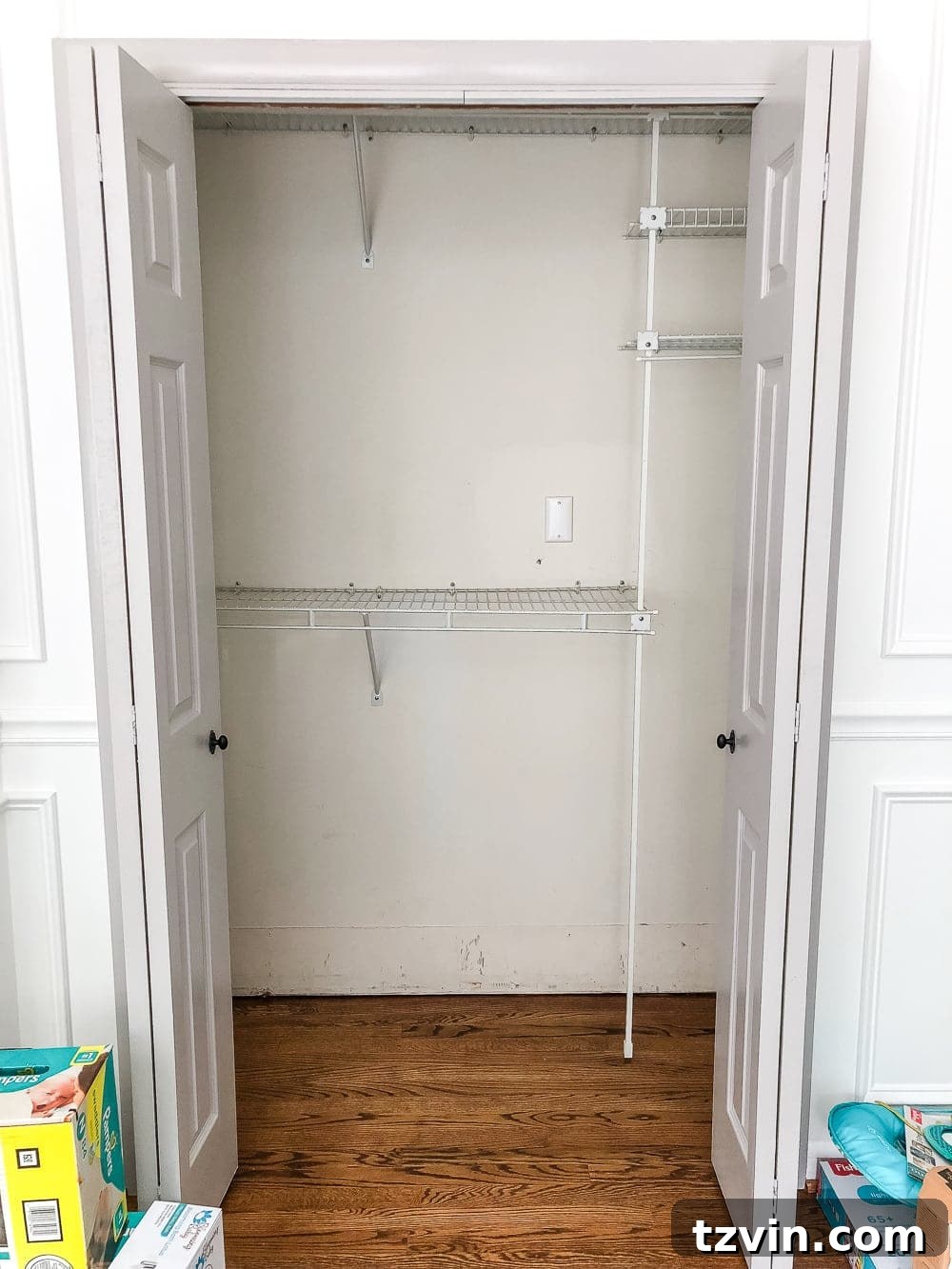 Nursery Closet Before with cluttered wire shelves
