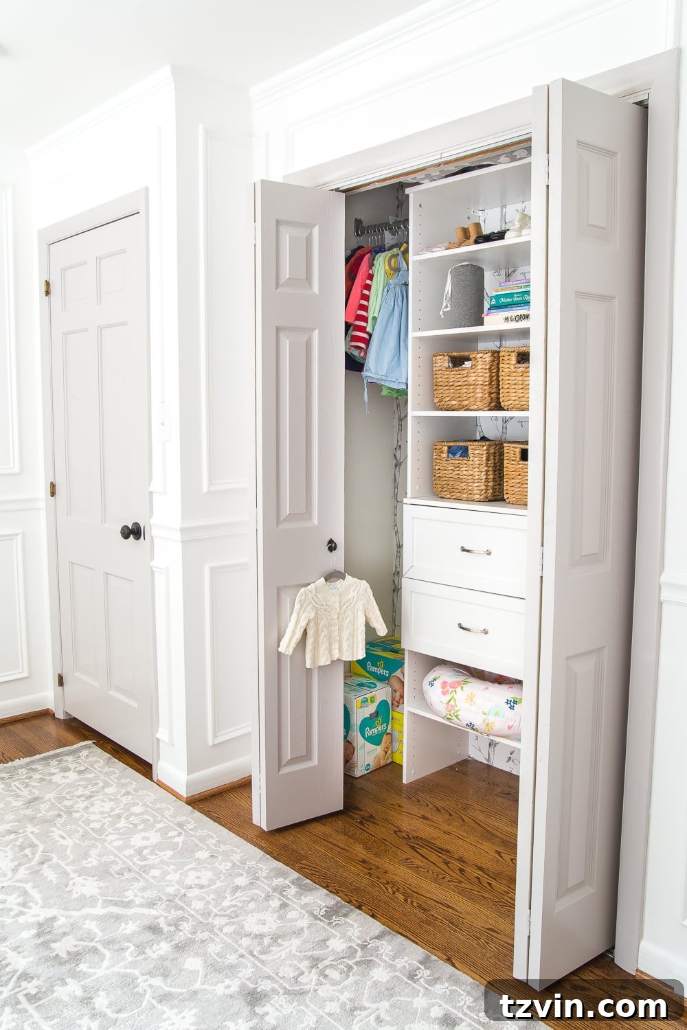 Well-designed nursery closet featuring multiple shelves and hanging space