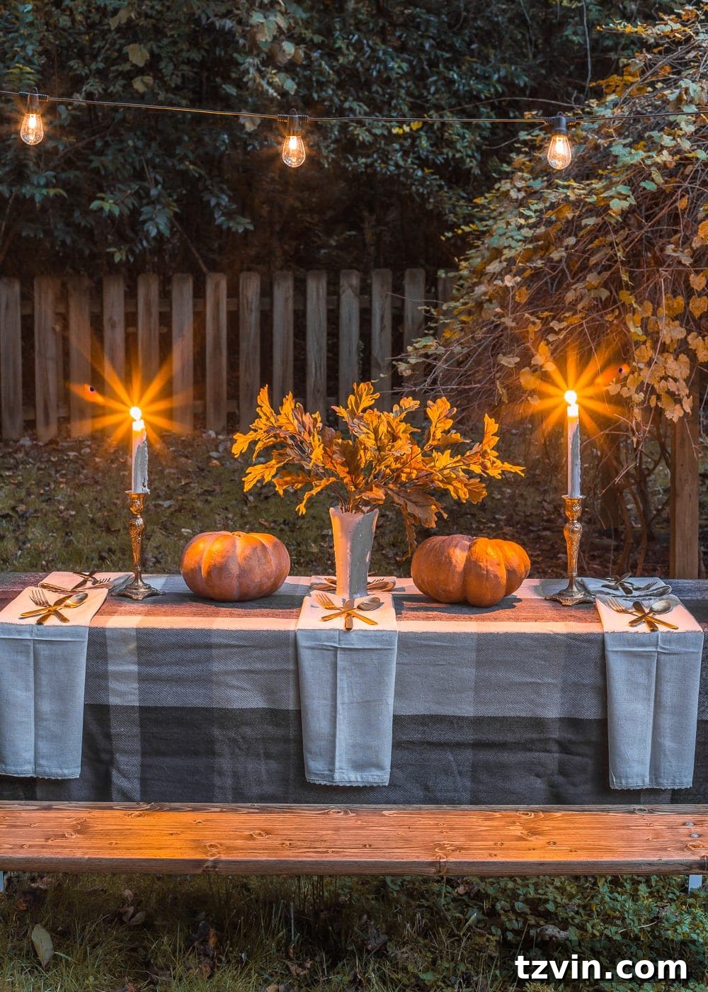 Outdoor Thanksgiving beer garden table with string lights glowing at dusk, showcasing the warm and inviting atmosphere.