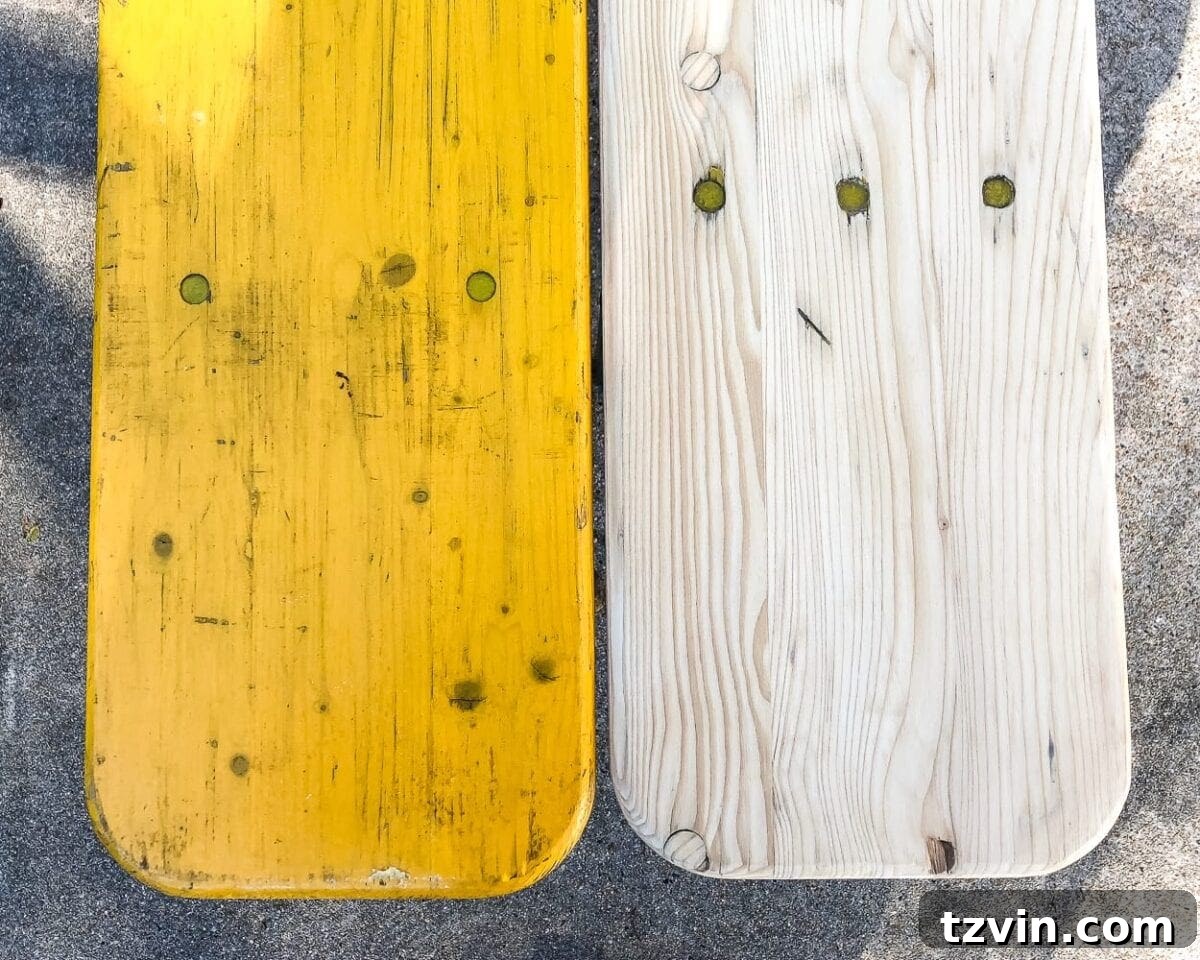 Detailed shot of the beer garden table leg being prepared, showing removed paint and clean metal surface.