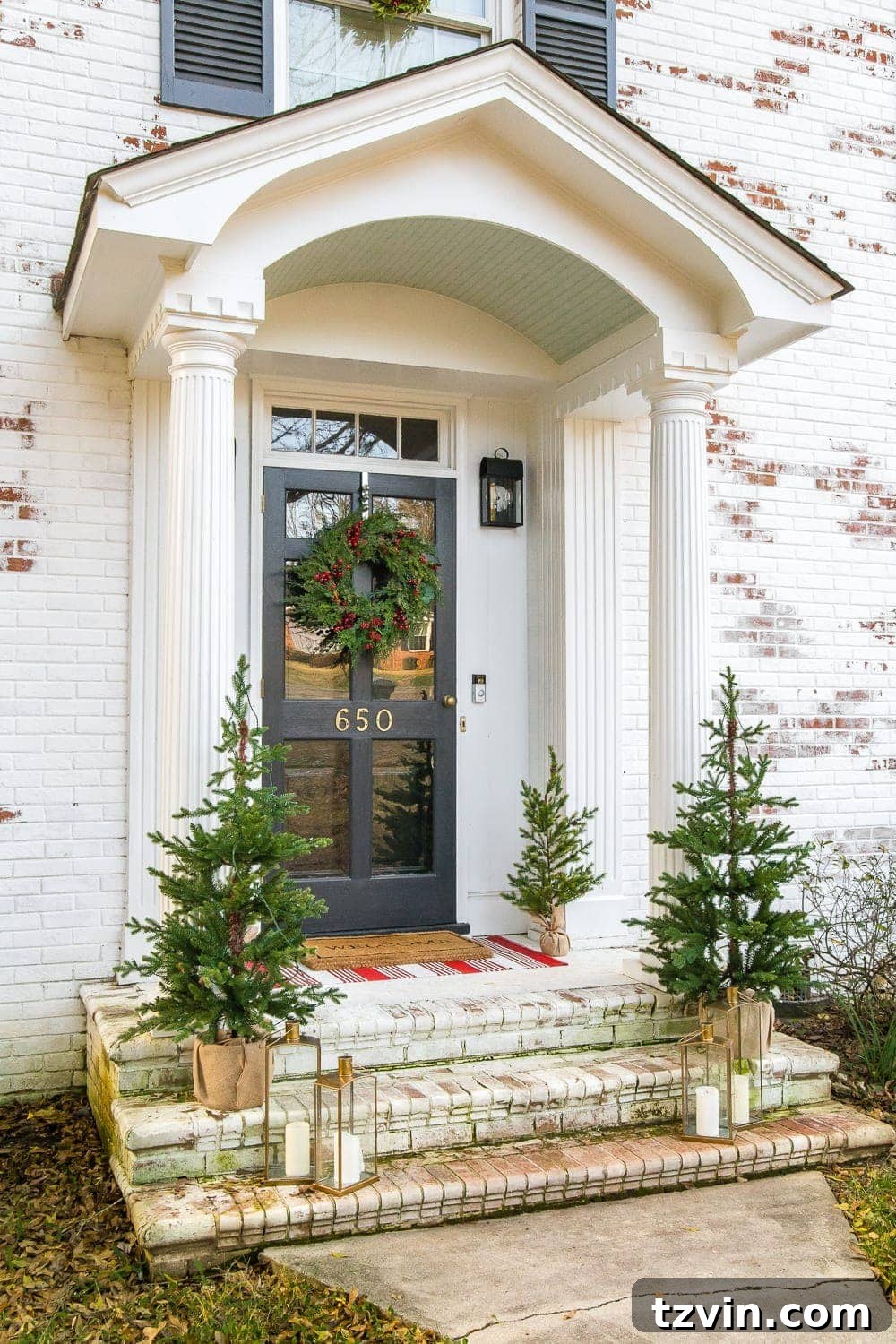 Colonial Charm Outdoor Christmas Wreaths 11 Small potted Christmas trees placed on the porch steps, adding extra greenery and festive charm.