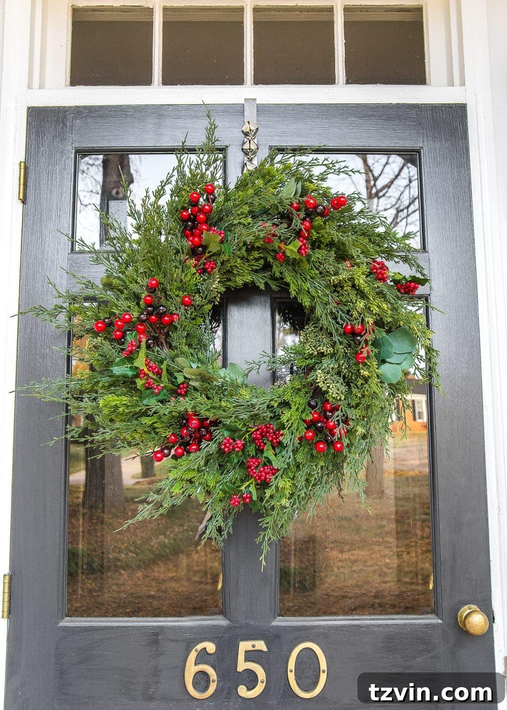 Colonial Charm Outdoor Christmas Wreaths 6 A beautifully decorated front door with a realistic Christmas wreath featuring cedar, holly, and eucalyptus.