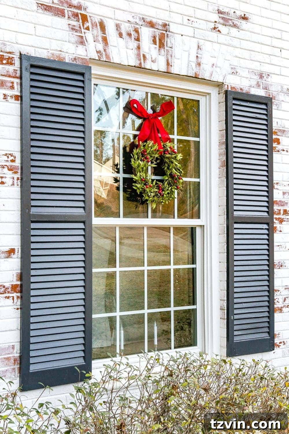 Colonial Charm Outdoor Christmas Wreaths 9 Another window featuring a beautiful, realistic boxwood Christmas wreath, adding festive charm to the exterior.