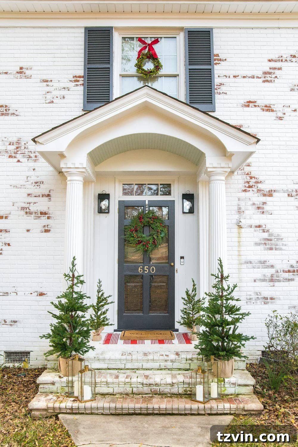 Colonial Charm Outdoor Christmas Wreaths 10 Layered welcome mats on a Christmas porch: a patterned accent rug beneath a traditional welcome mat.