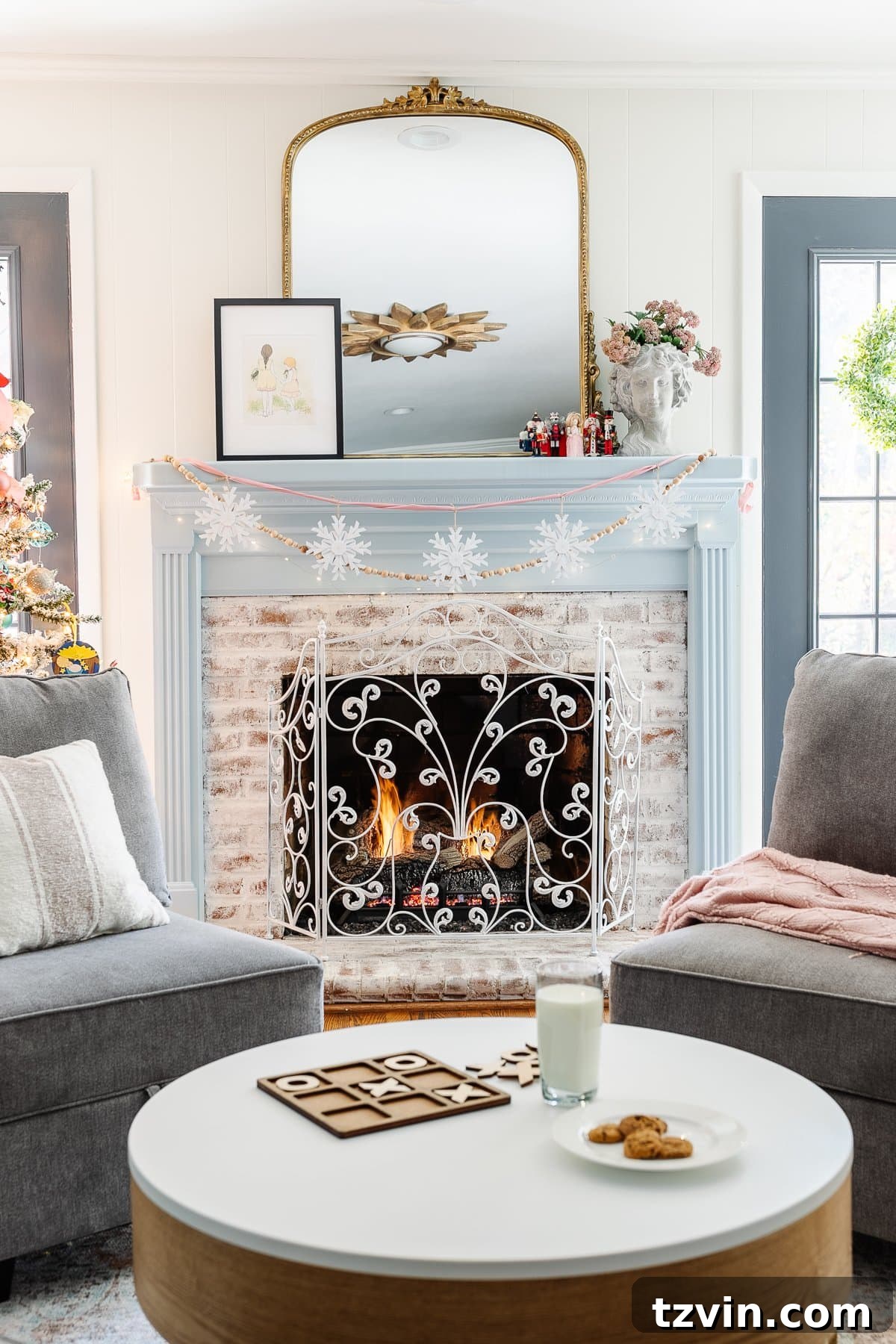 Handmade Holiday Magic: Affordable Christmas Decor for 2024 8 Snowflake ornaments strung onto ribbon create a charming DIY garland on a mantel, a simple and inexpensive Christmas decor idea.
