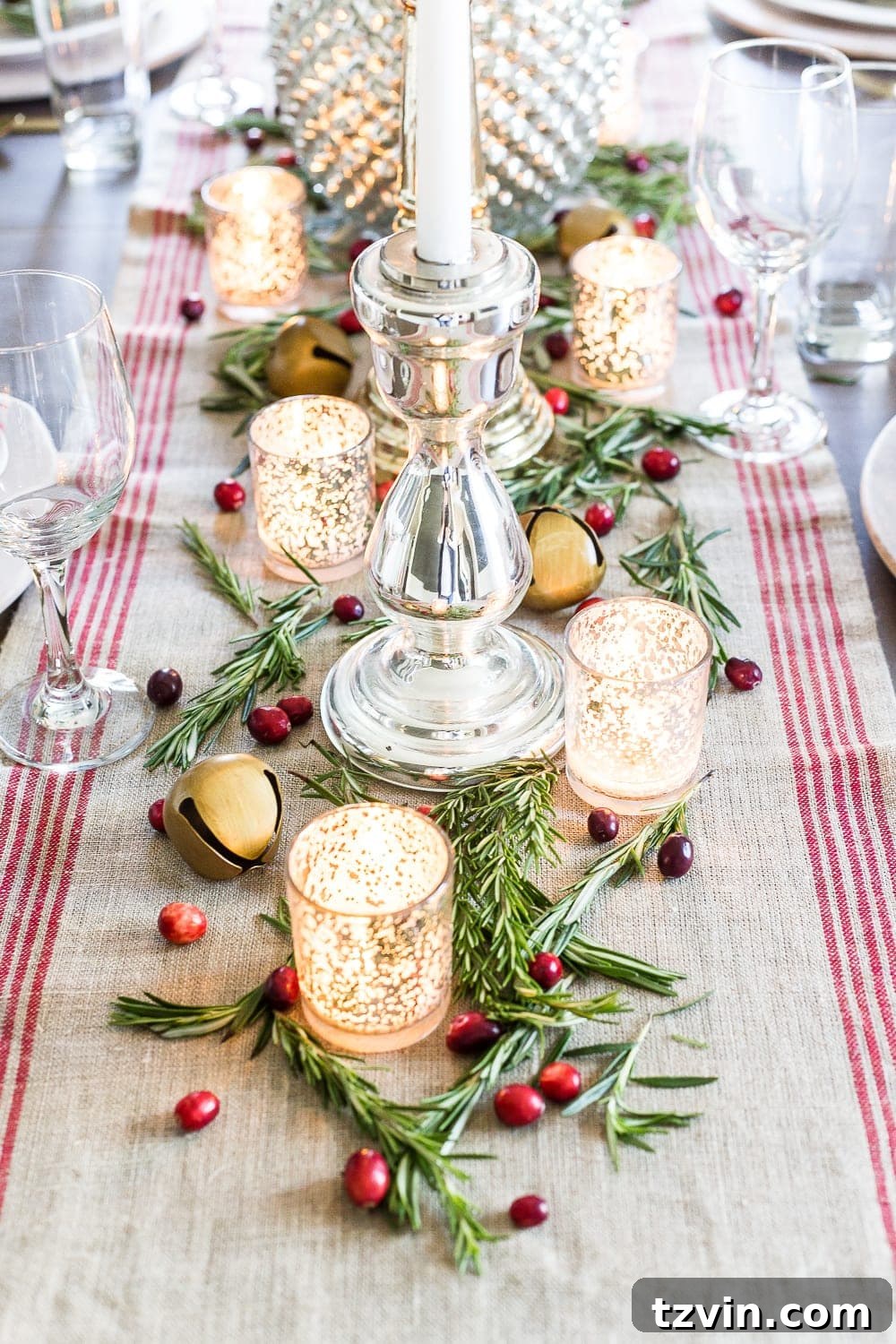 Handmade Holiday Magic: Affordable Christmas Decor for 2024 14 Scattering fresh rosemary and cranberries on a holiday centerpiece, a simple and aromatic Christmas decor idea.