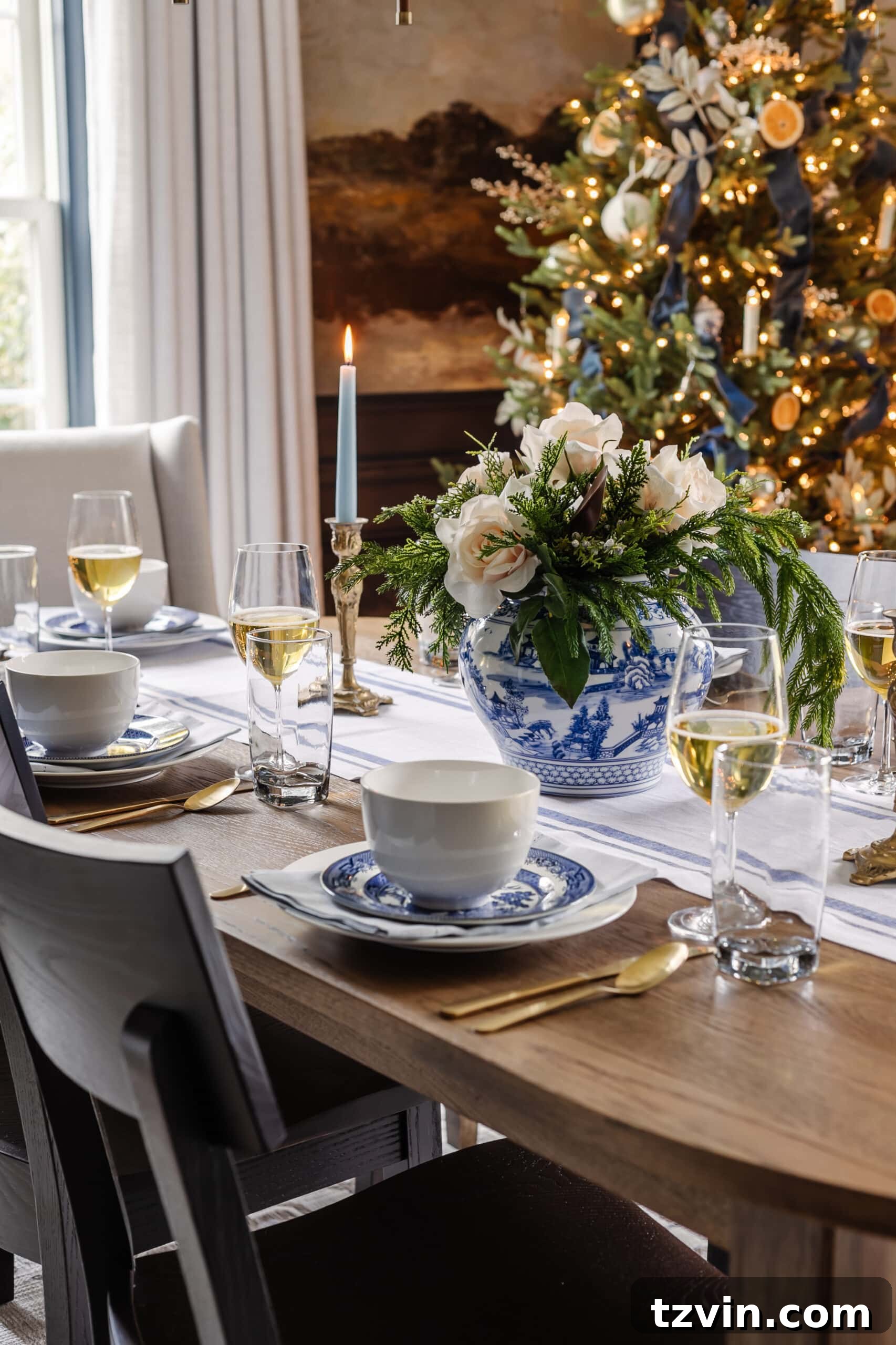 Handmade Holiday Magic: Affordable Christmas Decor for 2024 28 Christmas dining table elegantly decorated with vintage blue and white dishes from thrift stores, a beautiful and budget-friendly idea.