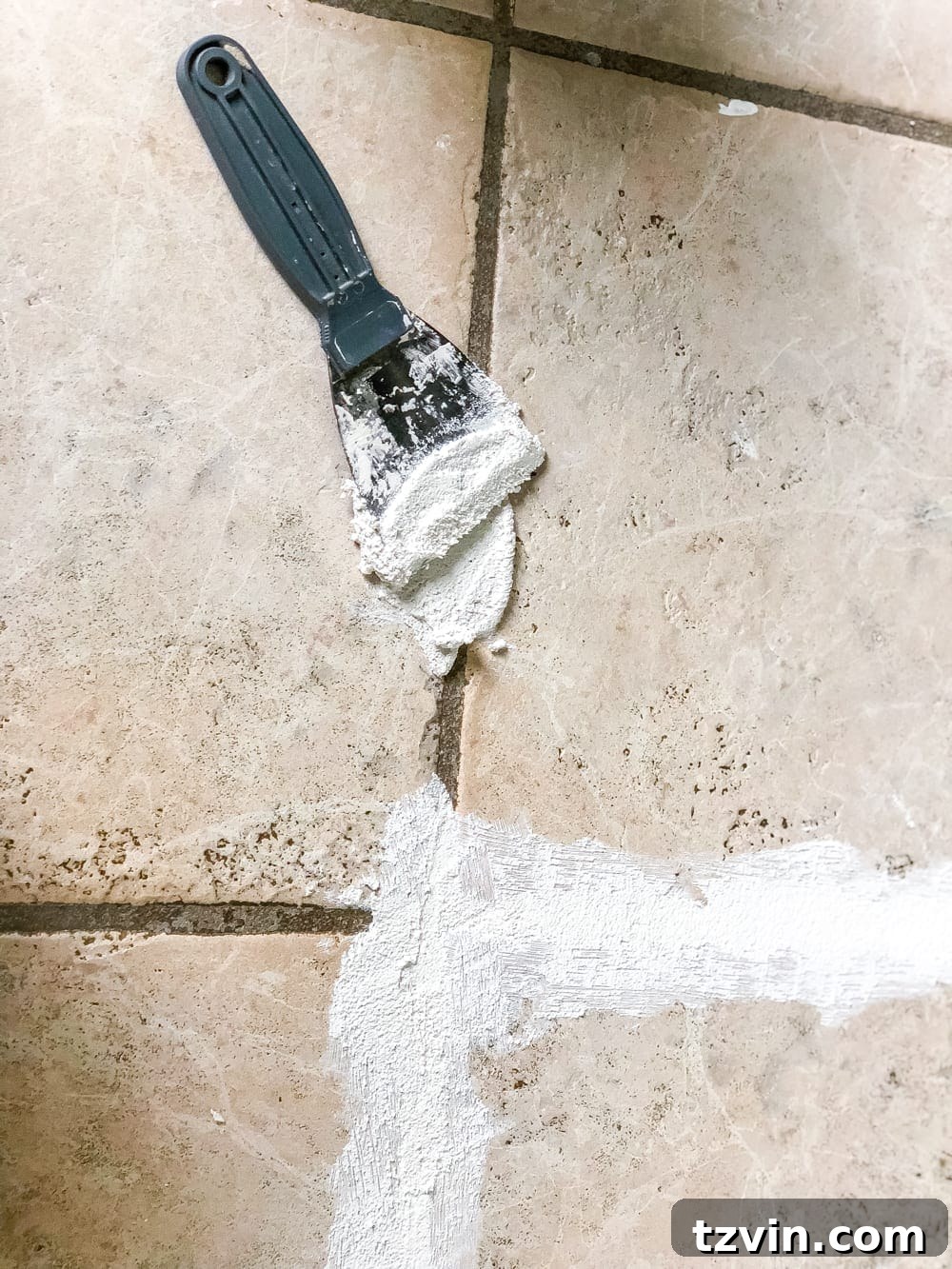 Install Sheet Vinyl Flooring Over Tile The Easy DIY Way 7 DIYer applying thin-set mortar to fill ceramic tile grout lines