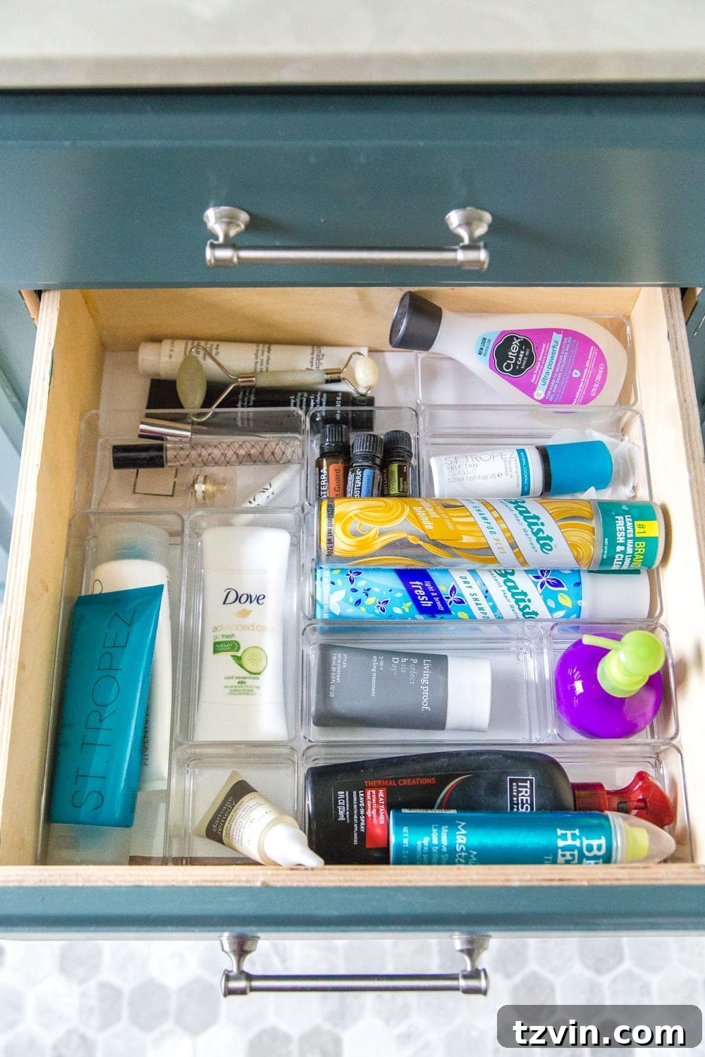 My organized bathroom drawer with skincare and haircare products, neatly arranged in clear dividers. #SkincareStorage #HaircareSolutions #PersonalDrawer