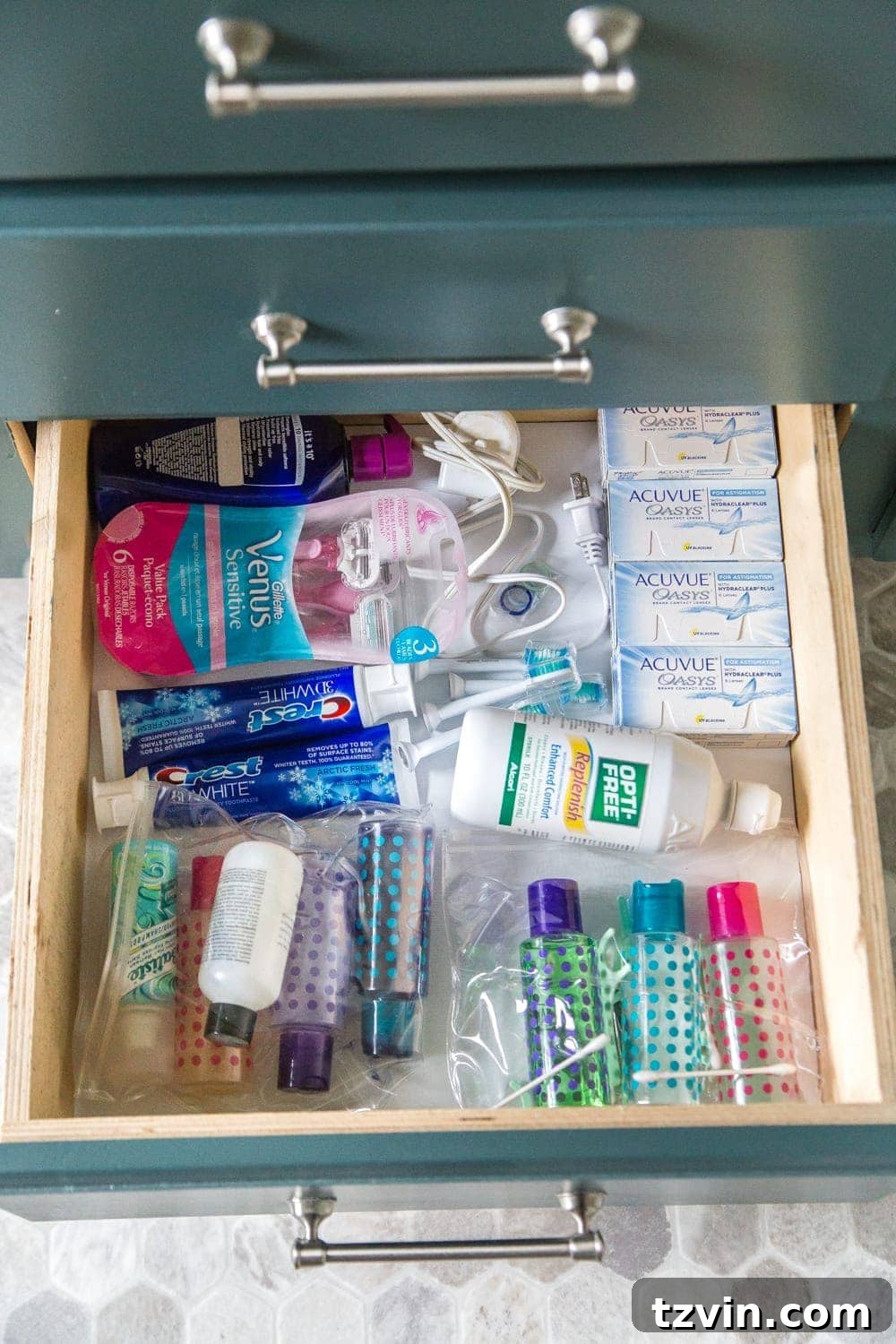 Bottom bathroom drawer with extra supplies and travel toiletry bags, demonstrating efficient storage for future use. #TravelOrganization #BulkStorage #Preparedness
