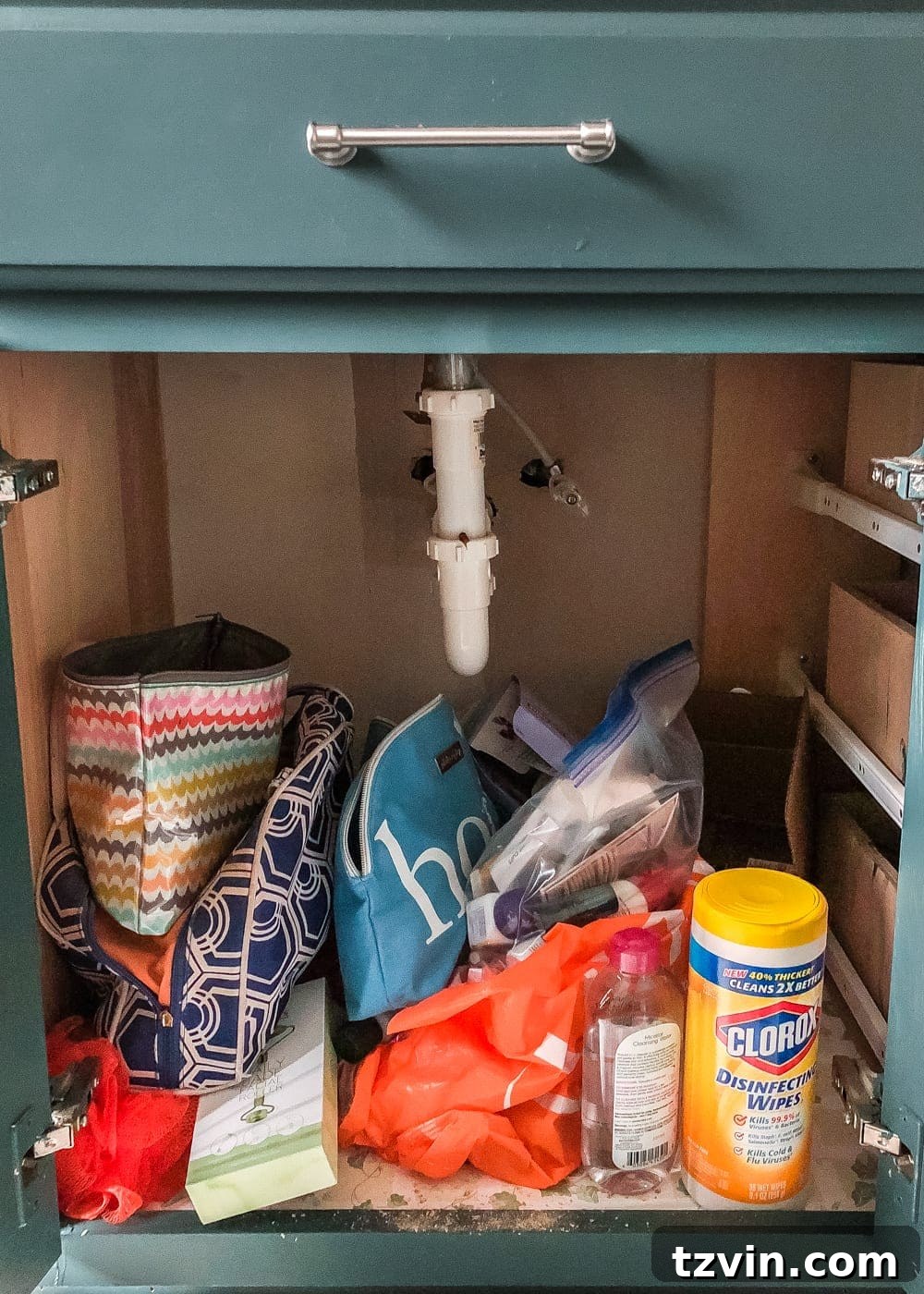 Extremely messy and disorganized bathroom vanity cabinet, packed with various items and lacking clear storage. #DisorganizedBathroom #VanityMess #RealLifeClutter