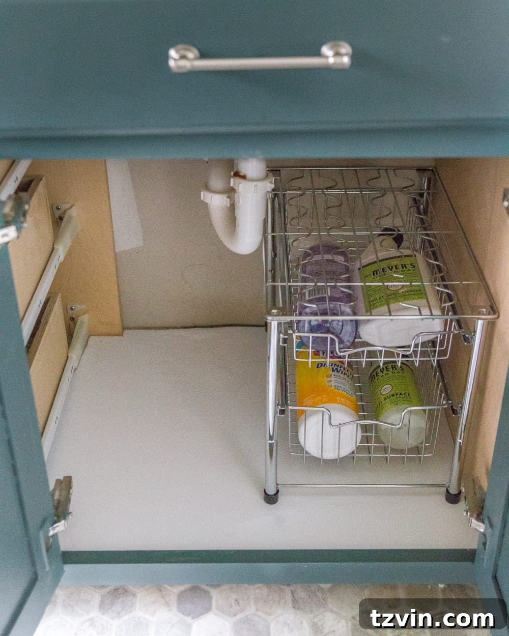 Neatly lined bathroom vanity drawer with fresh white wood grain contact paper, showing a significant improvement. #CleanDrawers #OrganizedHome #VanityUpgrade
