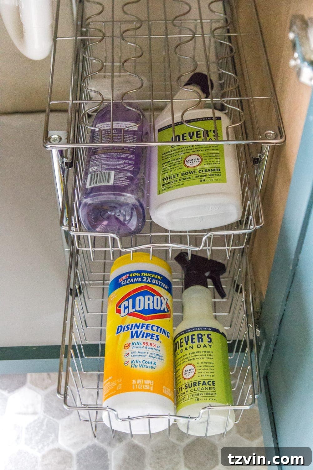 Robert's organized bathroom vanity cabinet with cleaning supplies neatly stored in baskets. #CleaningStorage #MensGrooming #PracticalStorage