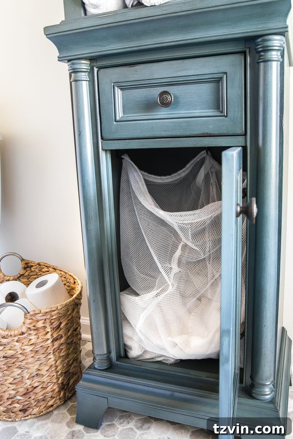 Master Bathroom Makeover: Stunning Results On A Budget 22 DIY hamper setup inside linen cabinet using a laundry bag