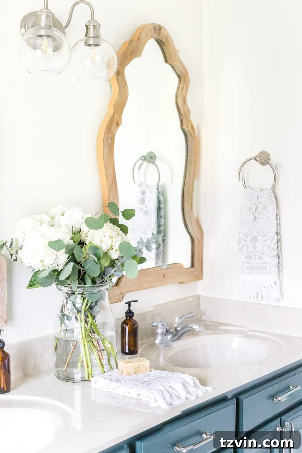 Master Bathroom Makeover: Stunning Results On A Budget 6 Stylish new two-light sconce above arch mirrors in a refreshed bathroom