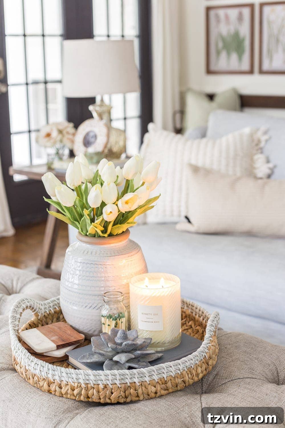 My Spring Oasis: A Home Tour 17 Coffee table styled for spring with artificial white tulips and neutral decor items.