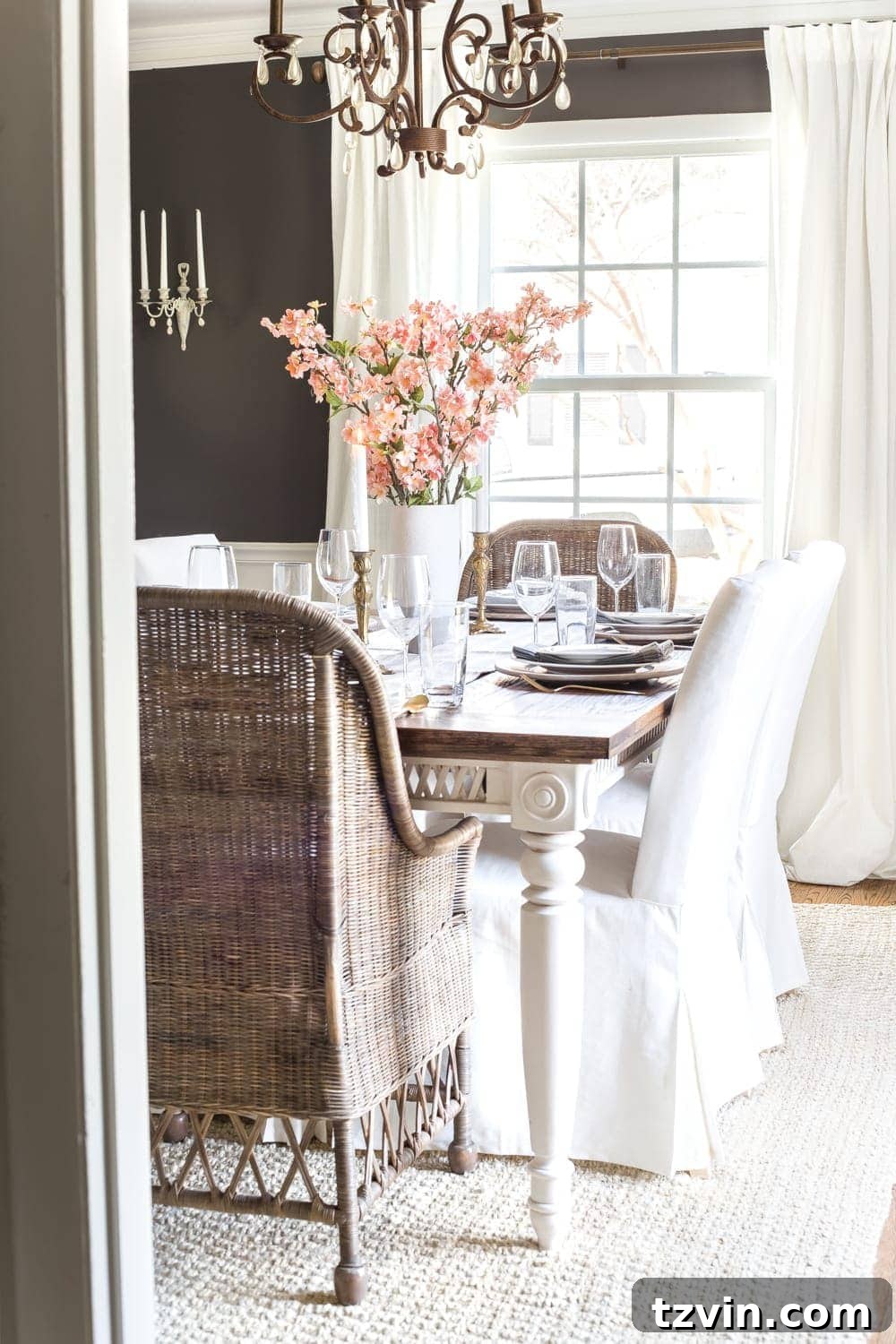 My Spring Oasis: A Home Tour 3 Elegant dining room decorated for spring with faux cherry blossoms in a stoneware vase.