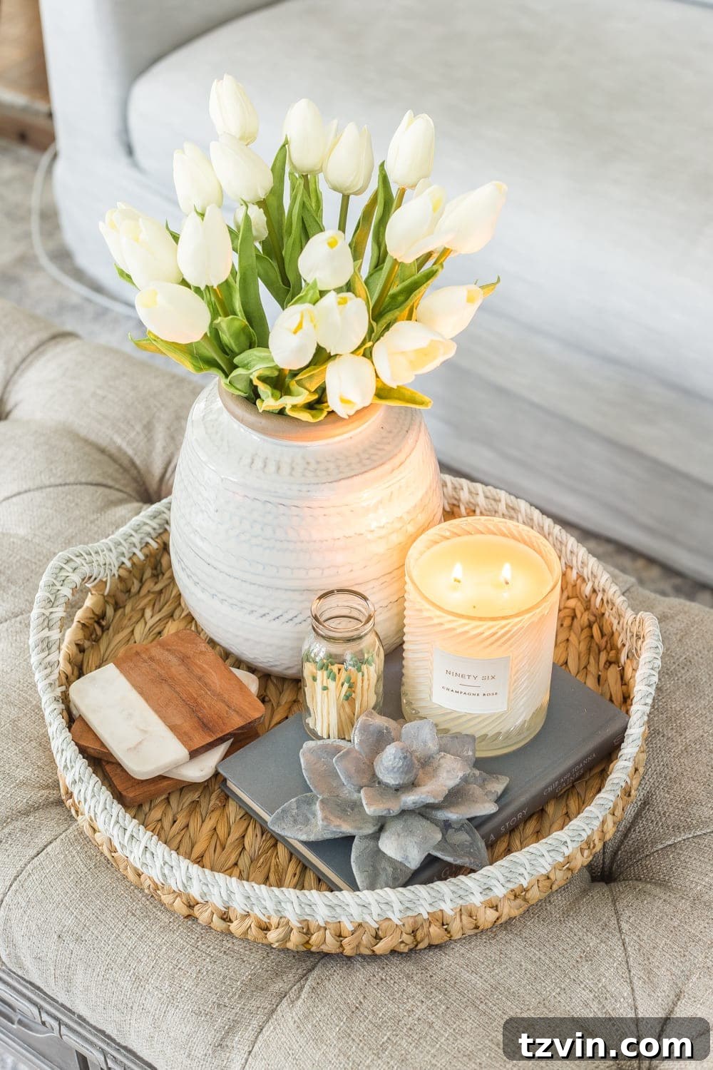 My Spring Oasis: A Home Tour 18 Living room coffee table with spring decor, including white artificial tulips and books.