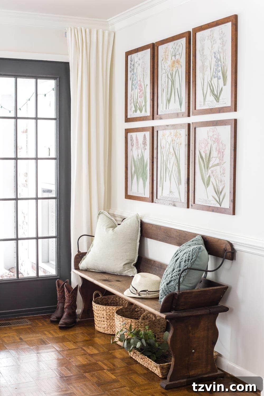 My Spring Oasis: A Home Tour 20 Makeshift mudroom with a Craigslist bench, storage baskets, and free botanical prints for spring decor.