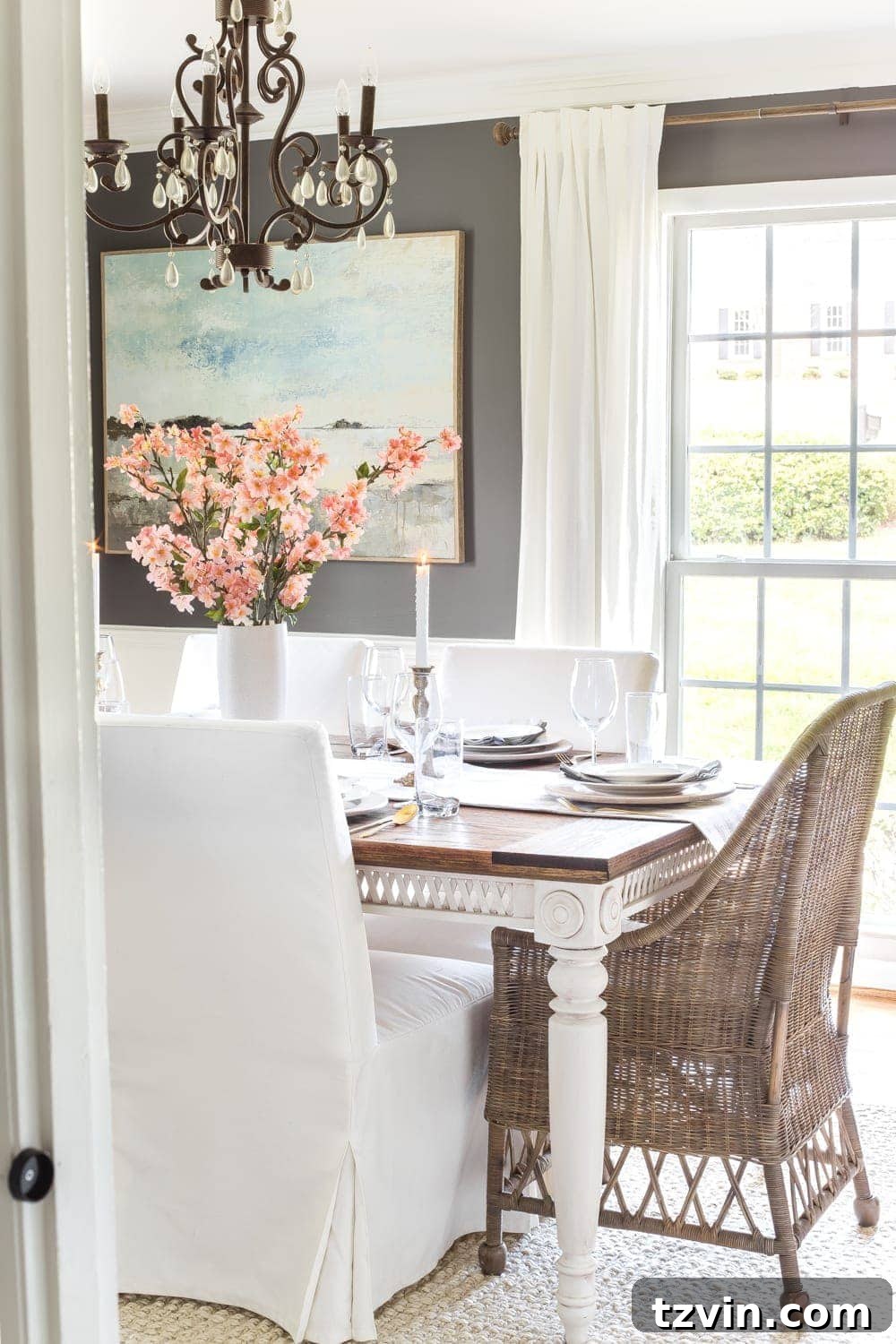 My Spring Oasis: A Home Tour 6 Elegant place setting with white china, wooden charger, and a delicate spring accent.