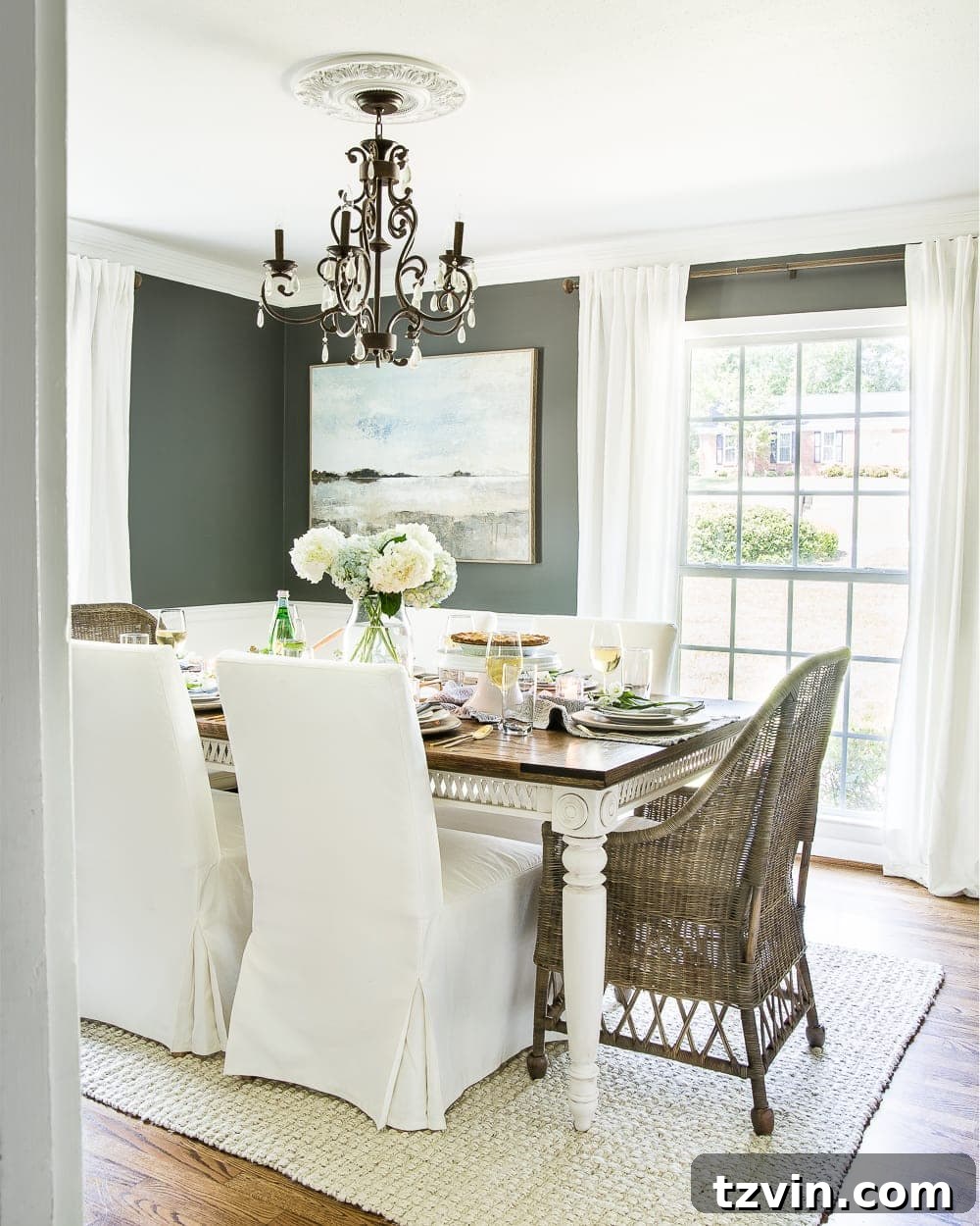 Two Years In: Our Home's Stunning Before and After 10 After image of a sophisticated dining room featuring dark gray walls, a large wooden table, and elegant lighting, embodying modern traditional design.