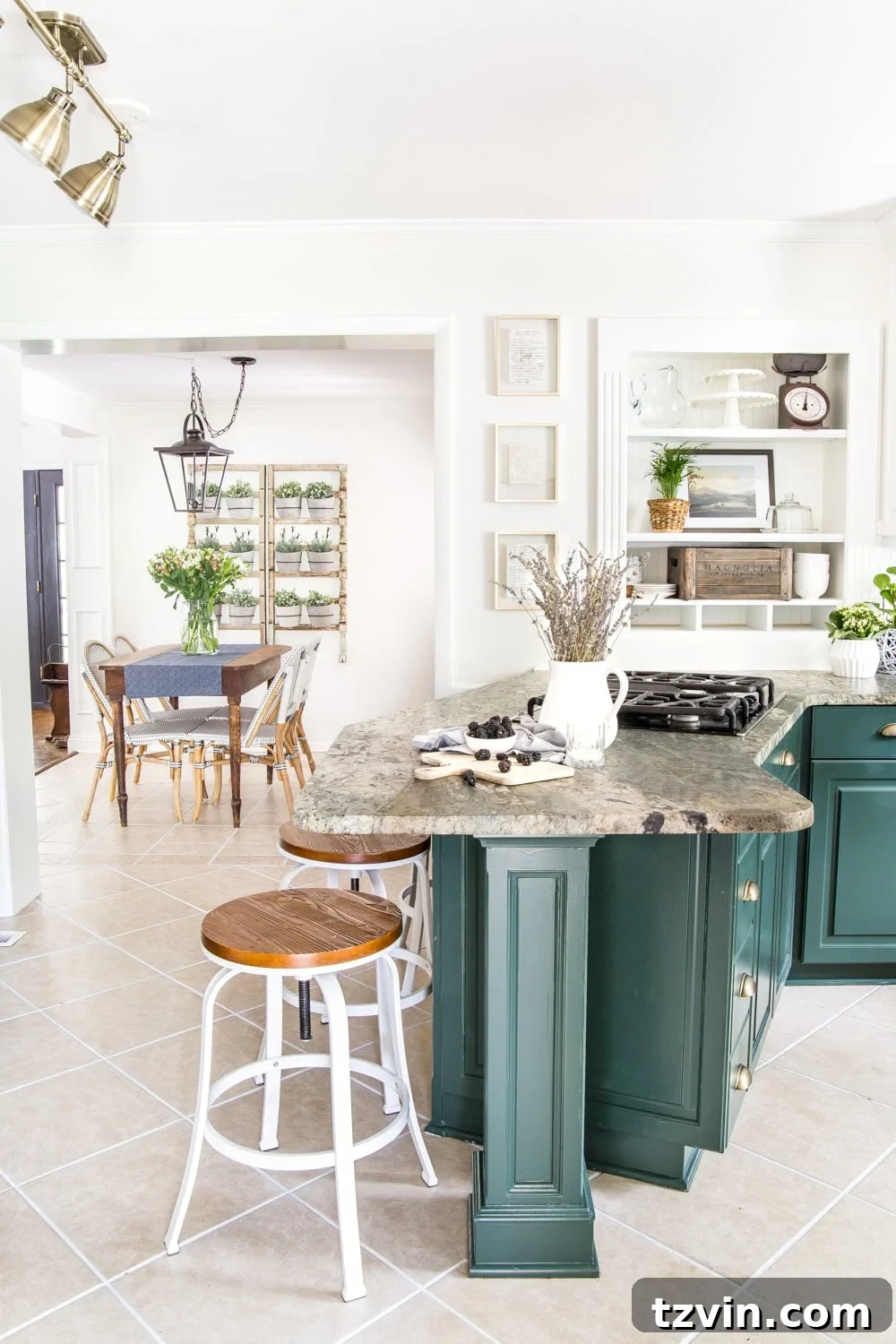 Two Years In: Our Home's Stunning Before and After 14 View of the renovated kitchen showcasing a spacious island, new lighting, and a blend of modern and rustic details.