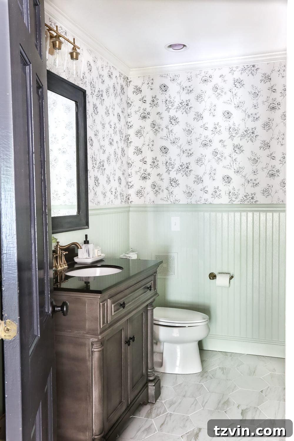 Two Years In: Our Home's Stunning Before and After 26 After image of an 'Aqua Meets Urban' powder room makeover, featuring beadboard paneling painted Hollingsworth Green and stylish modern fixtures.