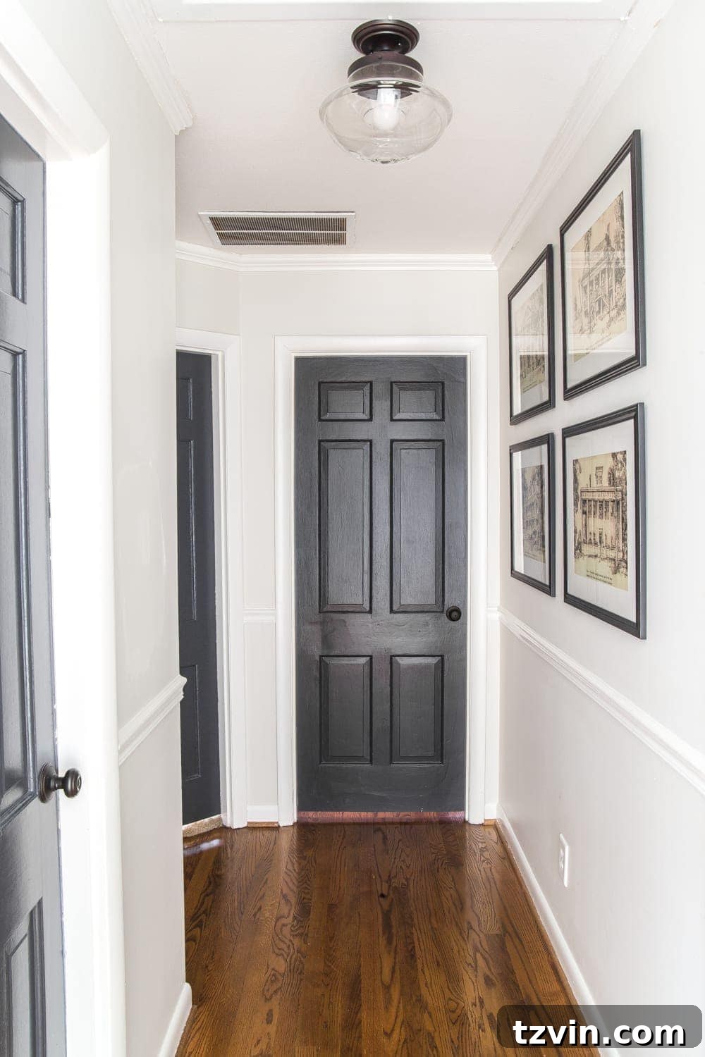 Two Years In: Our Home's Stunning Before and After 41 Close-up of framed architectural printable art adorning the hallway wall, adding a sophisticated and personal touch.