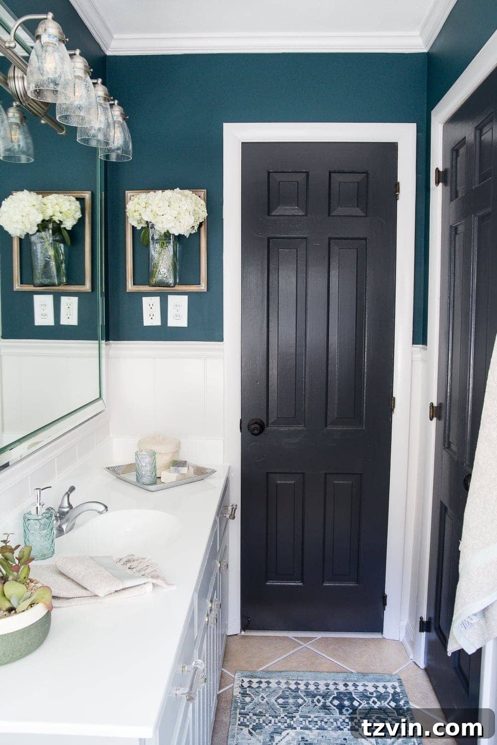 Two Years In: Our Home's Stunning Before and After 54 Detailed shot of the kids' bathroom mirror, lighting, and a small plant, adding a fresh and clean aesthetic.