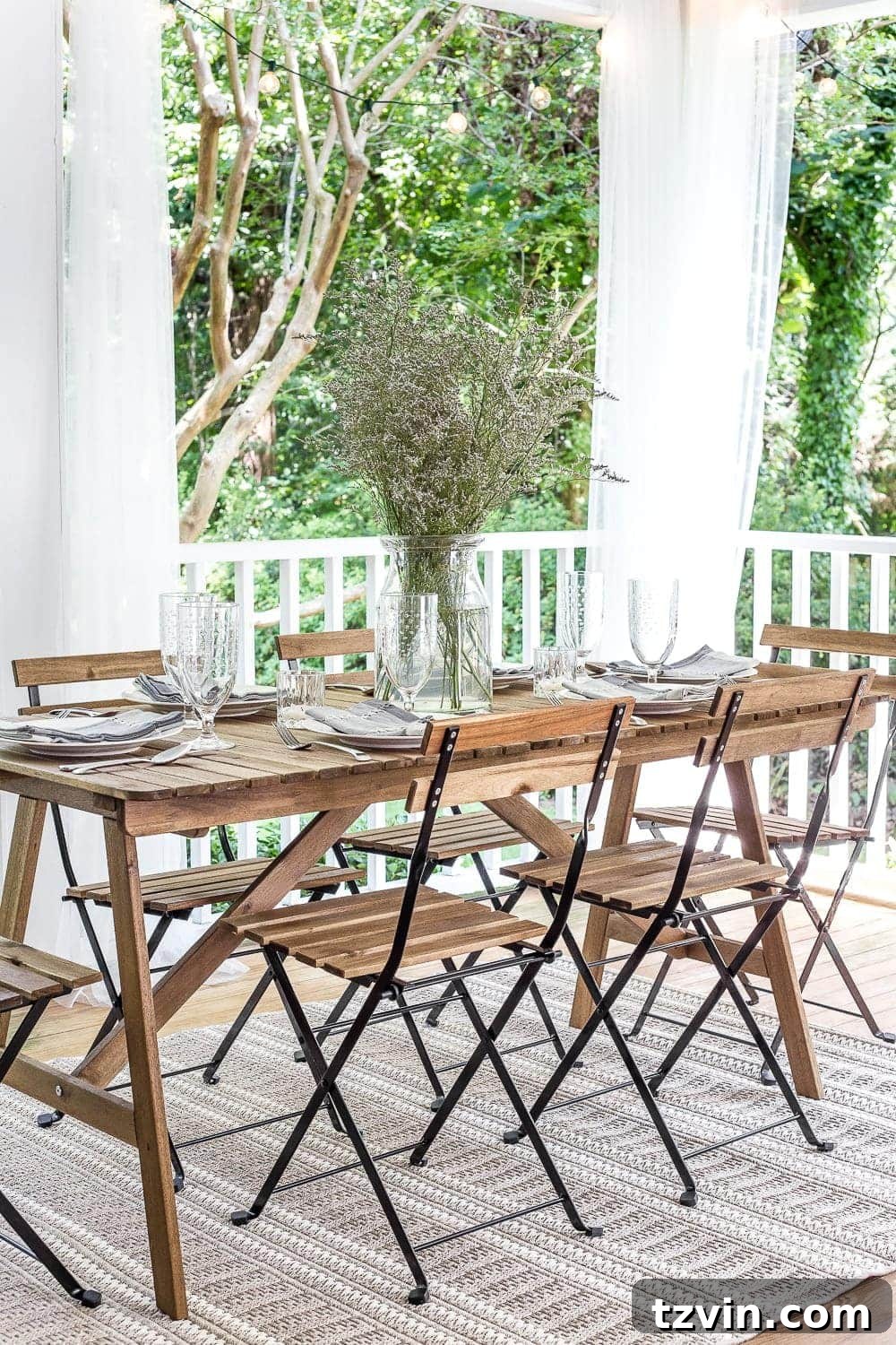 Two Years In: Our Home's Stunning Before and After 65 View of the back porch showcasing seasonal decor, including potted plants and throw pillows, enhancing the cozy outdoor living experience.