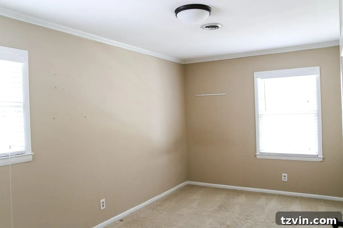 Two Years In: Our Home's Stunning Before and After 71 Before image of a spare bedroom with minimal decor, designated to become a guest room.