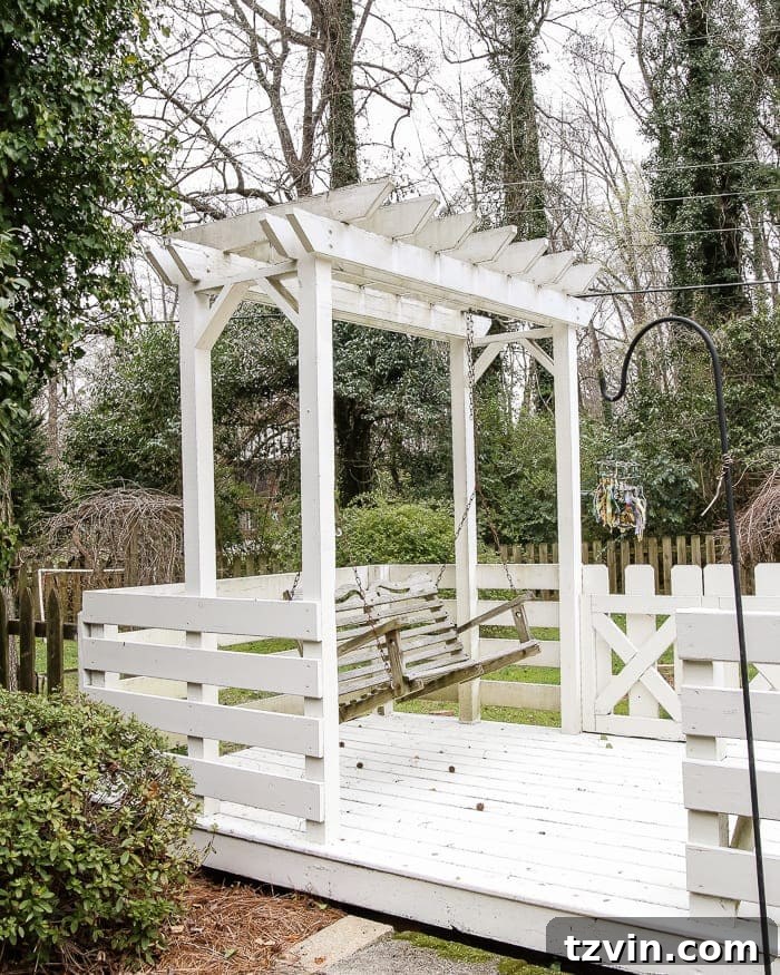 Two Years In: Our Home's Stunning Before and After 73 Before image of a backyard with unkempt landscaping and an old fence, illustrating its potential for a complete overhaul.