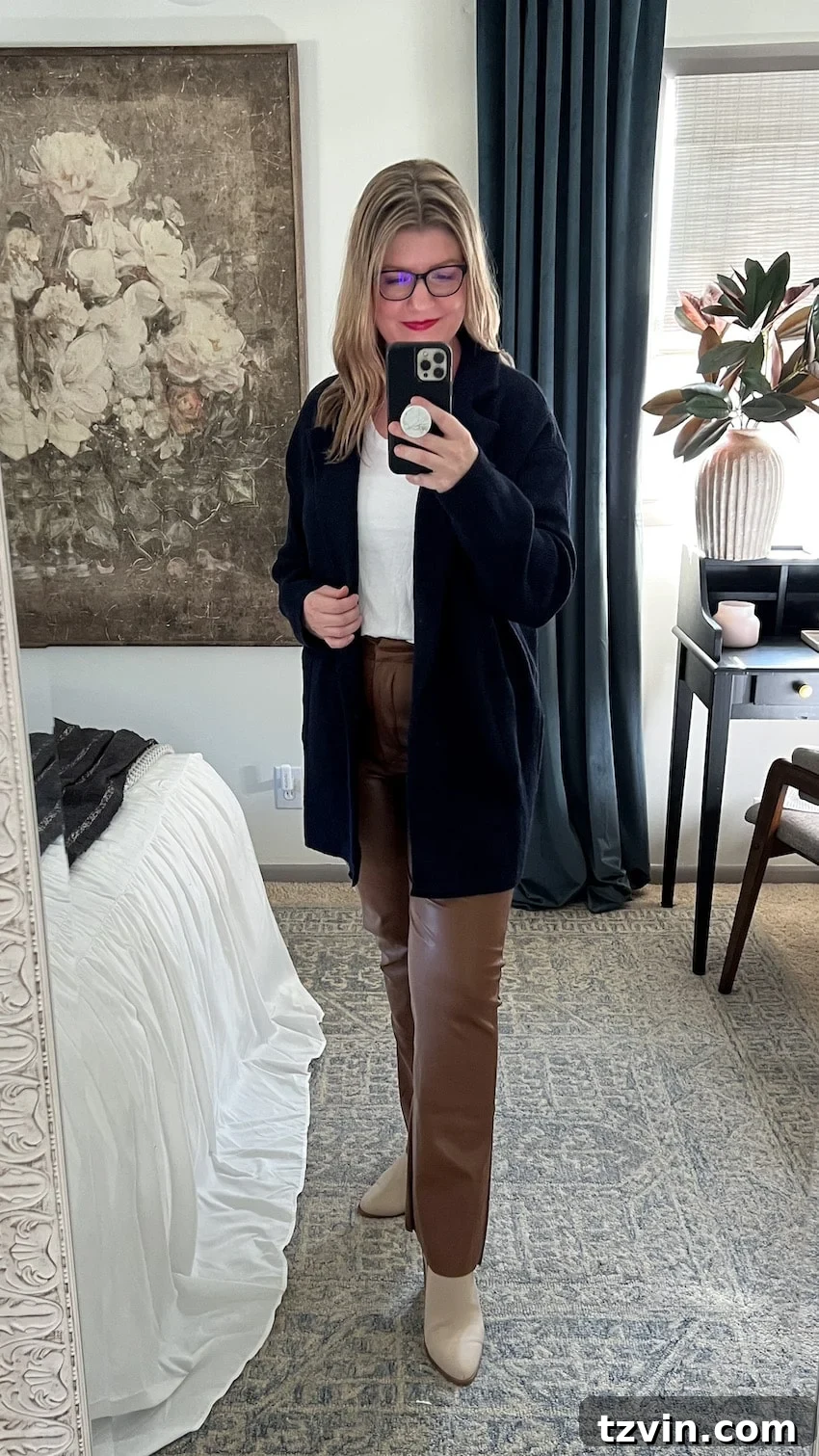 postpartum outfit with leather pants, tee, and cardigan