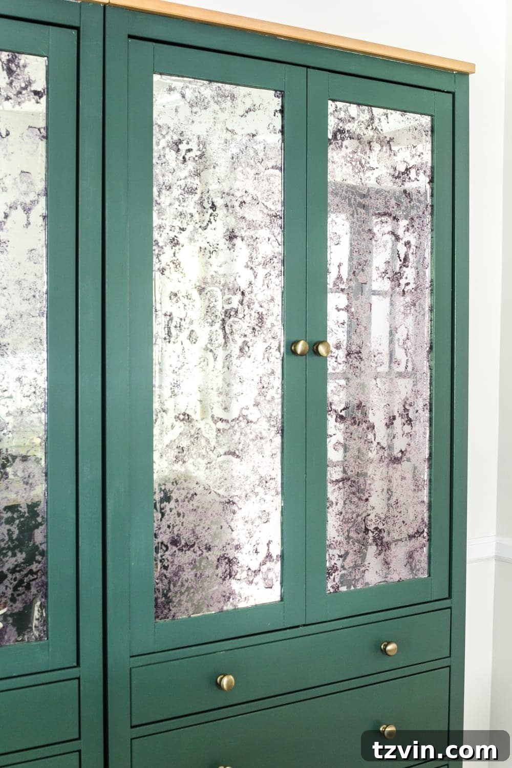 Hacking IKEA Hemnes for Your Pantry 15 Smoothing antique mirror film on a DIY pantry cabinet made from IKEA Hemnes