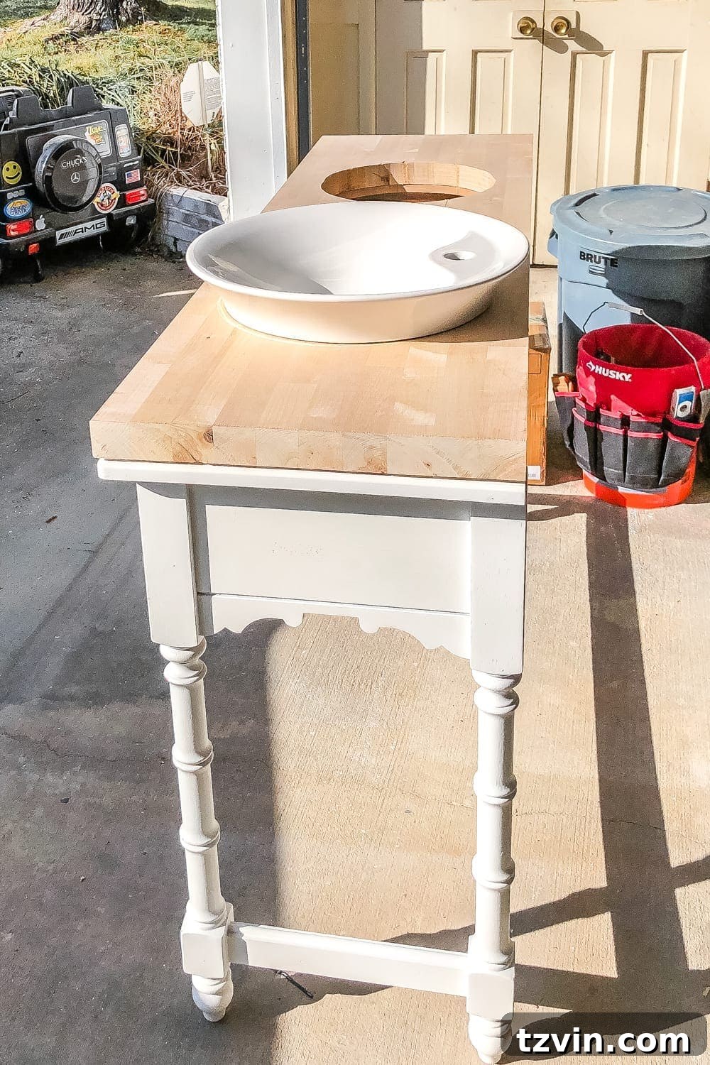 Upcycling a Console Table into a Chic Bathroom Vanity 12 Testing the fit of the vessel sinks and butcher block countertop