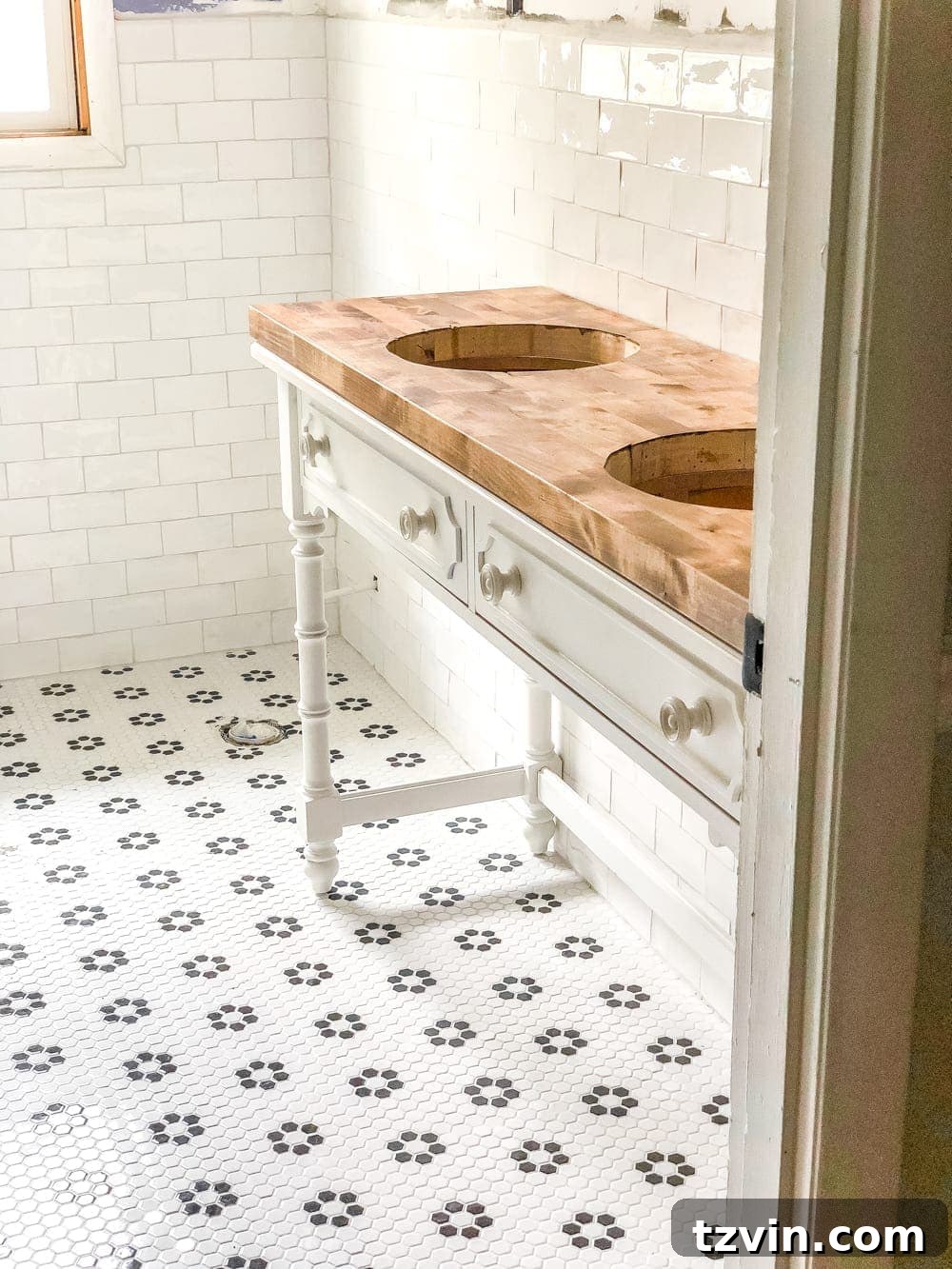 Upcycling a Console Table into a Chic Bathroom Vanity 14 Applying clear silicone caulk to seal the vanity countertop against the wall