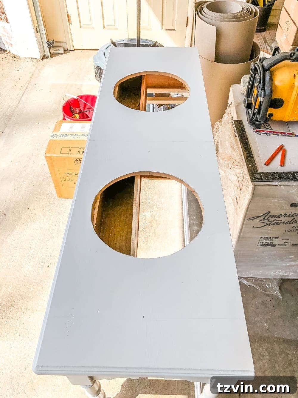 Upcycling a Console Table into a Chic Bathroom Vanity 10 Cutting the sink holes into the console table top with a jigsaw