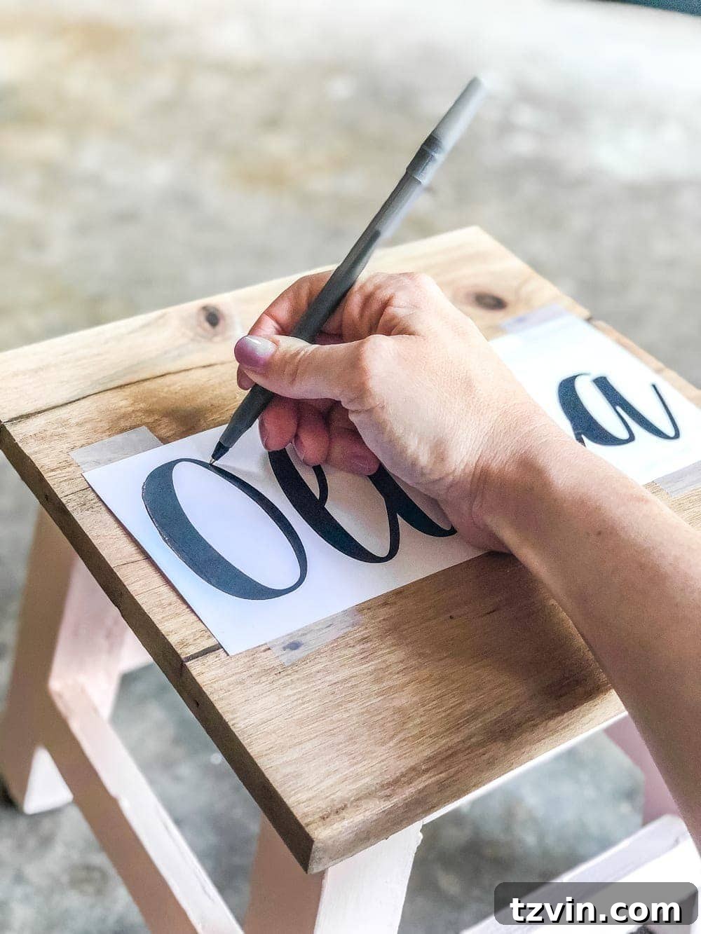 Craft Your Own Custom Step Stool 7 DIY Personalized Step Stools - Tracing name onto wood for painting guide. #personalizedstepstool #diysign #diymonogram