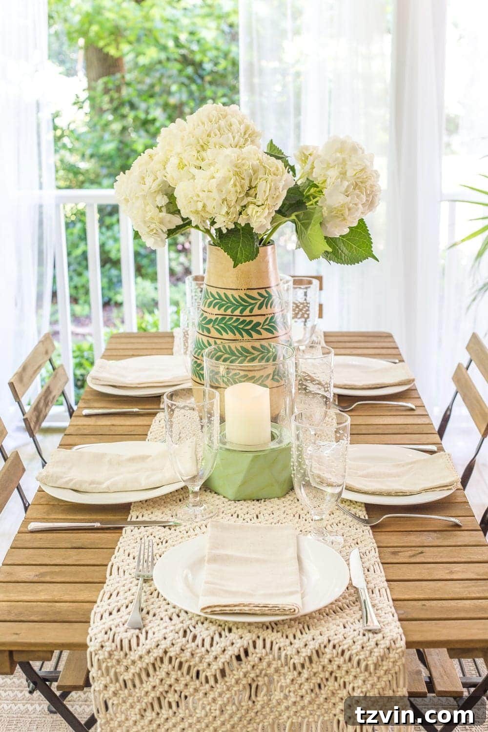 Vase of fresh hydrangeas on an outdoor table, adding natural beauty to the tropical boho back porch.