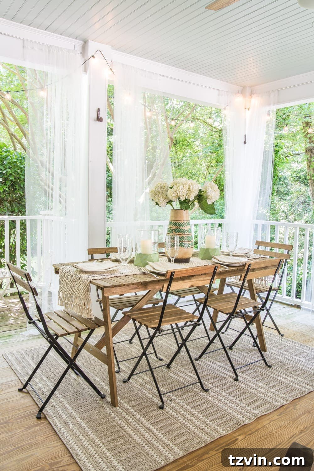 Overhead view of the tropical boho back porch at dusk, highlighting string lights and comfortable seating.
