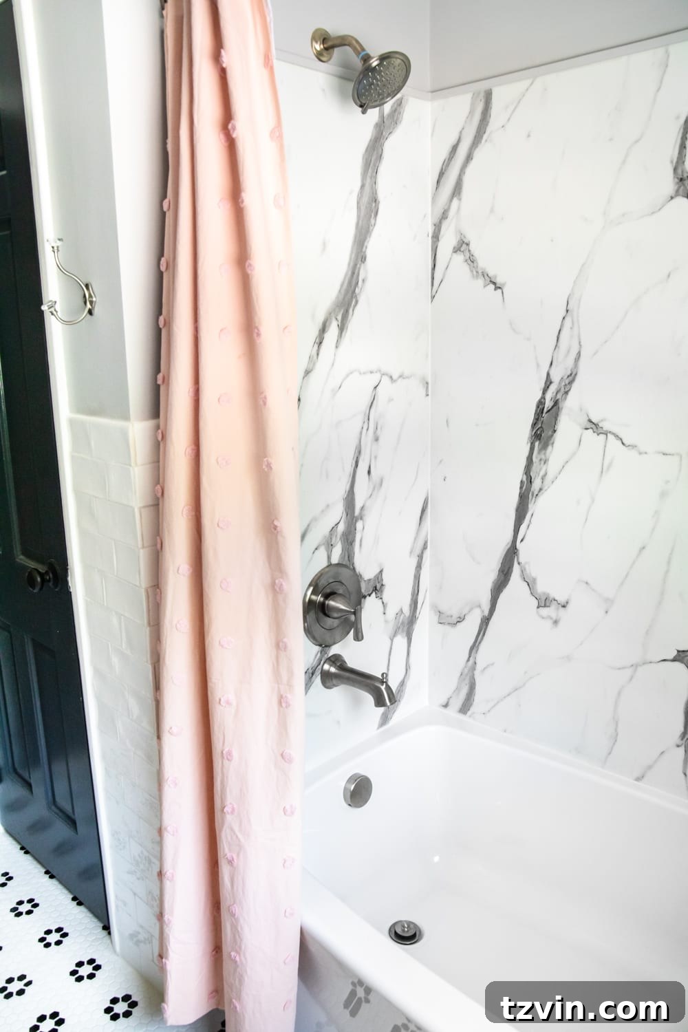 Tiny Humans Big Bathroom Makeover 11 Modern tub and shower faucet with faux marble shower walls