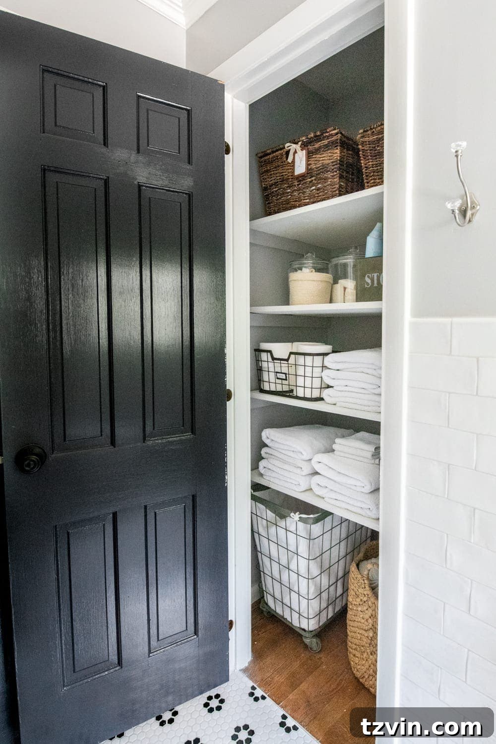 Tiny Humans Big Bathroom Makeover 19 Detailed view of linen closet organization with various baskets and storage solutions
