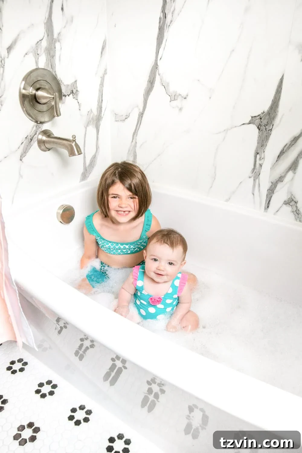 Tiny Humans Big Bathroom Makeover 23 Whimsical classic kids bathroom with faux marble shower and pastel accents