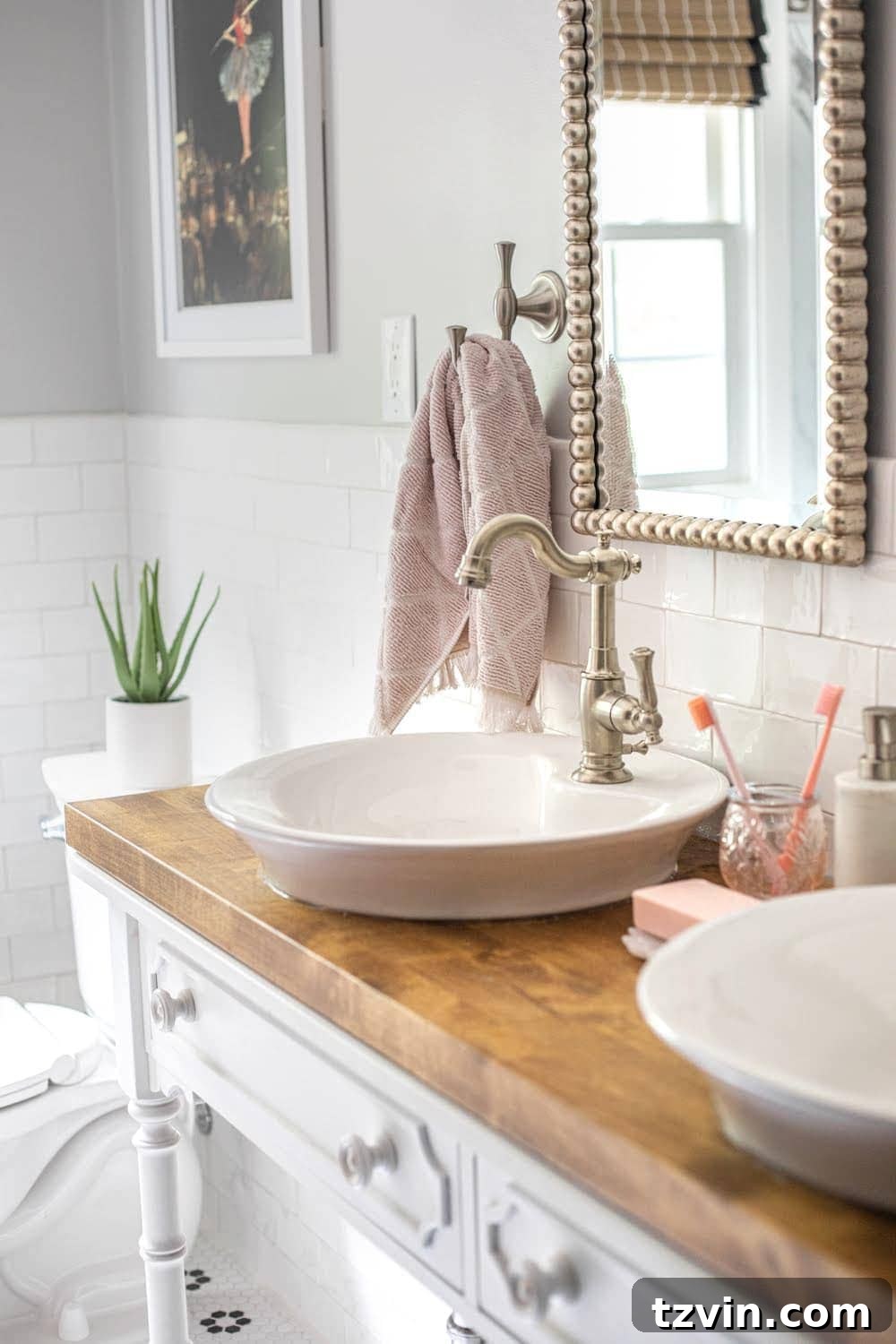 Tiny Humans Big Bathroom Makeover 6 Close-up of dual vessel sinks on a converted console table vanity with brass hardware