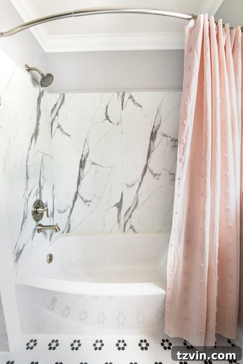 Tiny Humans Big Bathroom Makeover 9 Newly installed faux marble shower with a curved tub, showcasing modern fixtures