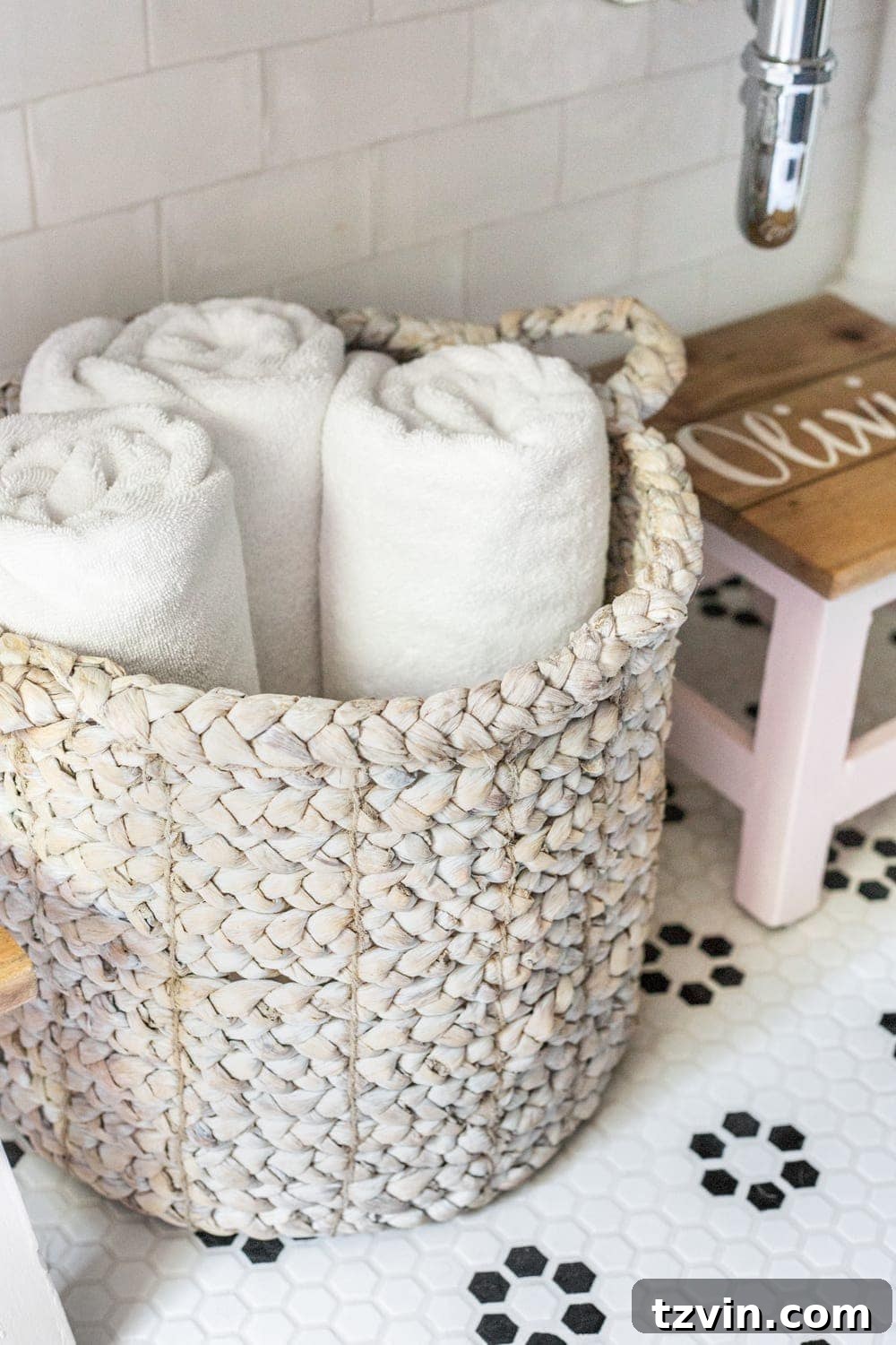 Girls' Bathroom Decor Details & Sources | basket of towels underneath an open vanity table