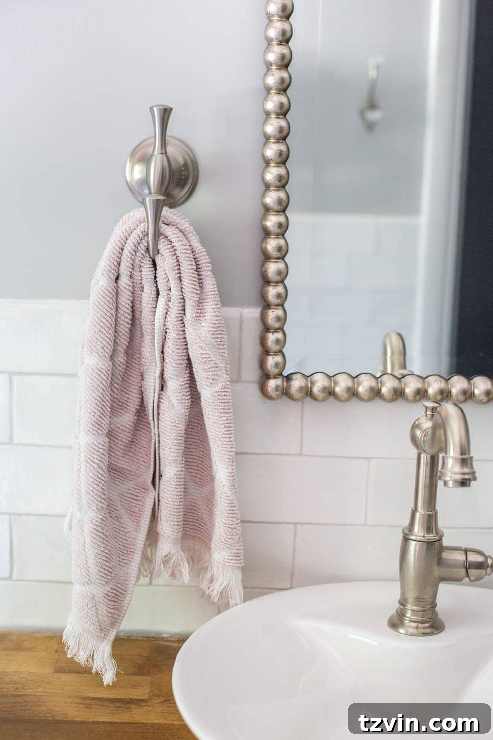 Girls' Bathroom Decor Details & Sources | hand towel hook, beaded mirror, vessel sink on butcher block countertop
