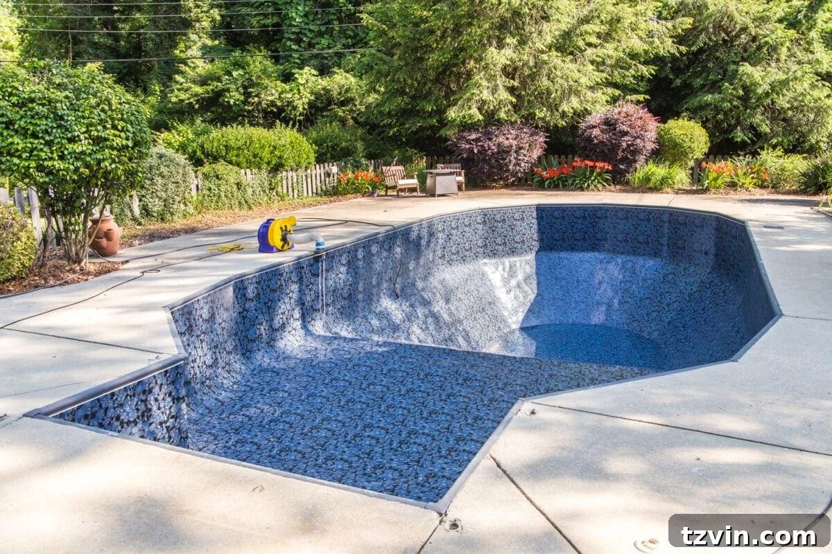 Newly installed Obsidian pool liner beginning to fill with water, showcasing its beauty